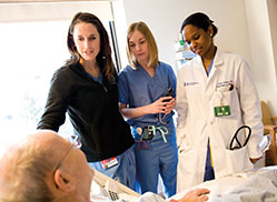 Photo of nurses with a patient. Links to Gifts from Retirement Plans