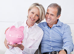 Photo of a couple with a piggy bank. Links to Gifts by Will